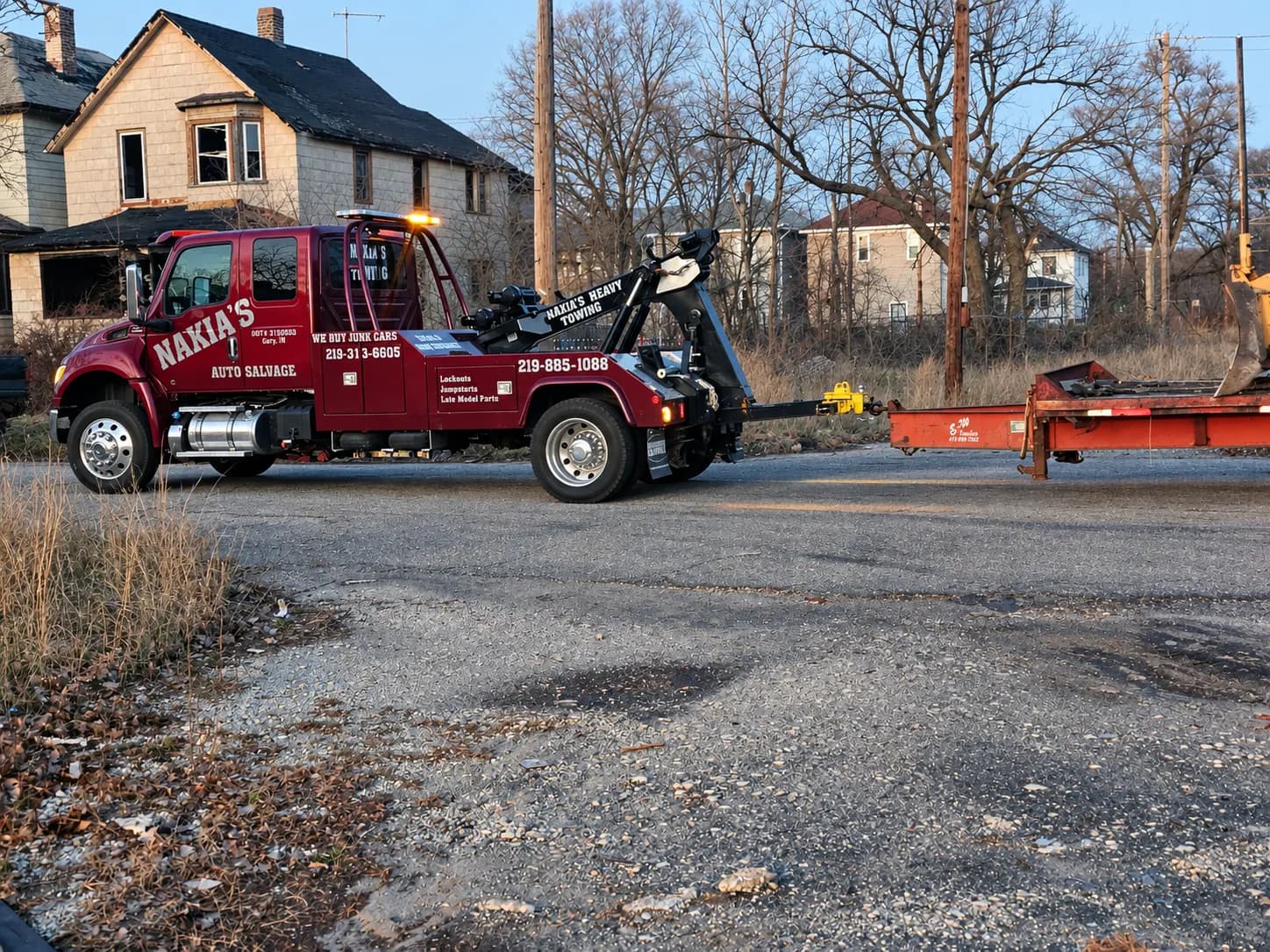 Nakia's wrecker towing an equipment trailer