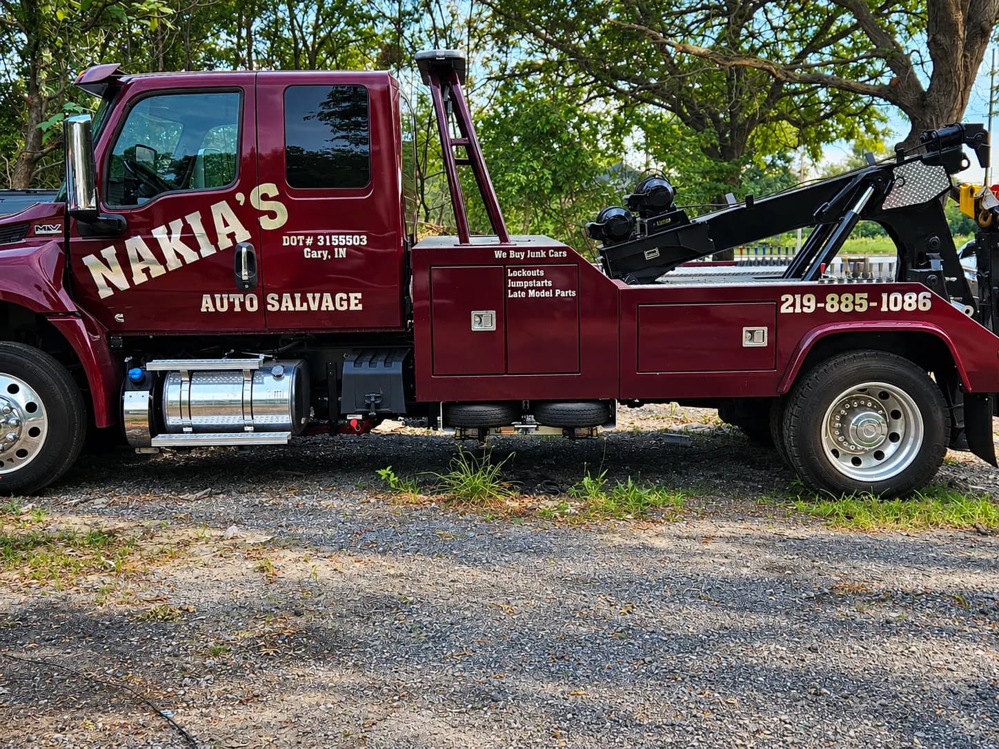 Side of Nakia's Auto Salvage wrecker with its 219-885-1086 lettering