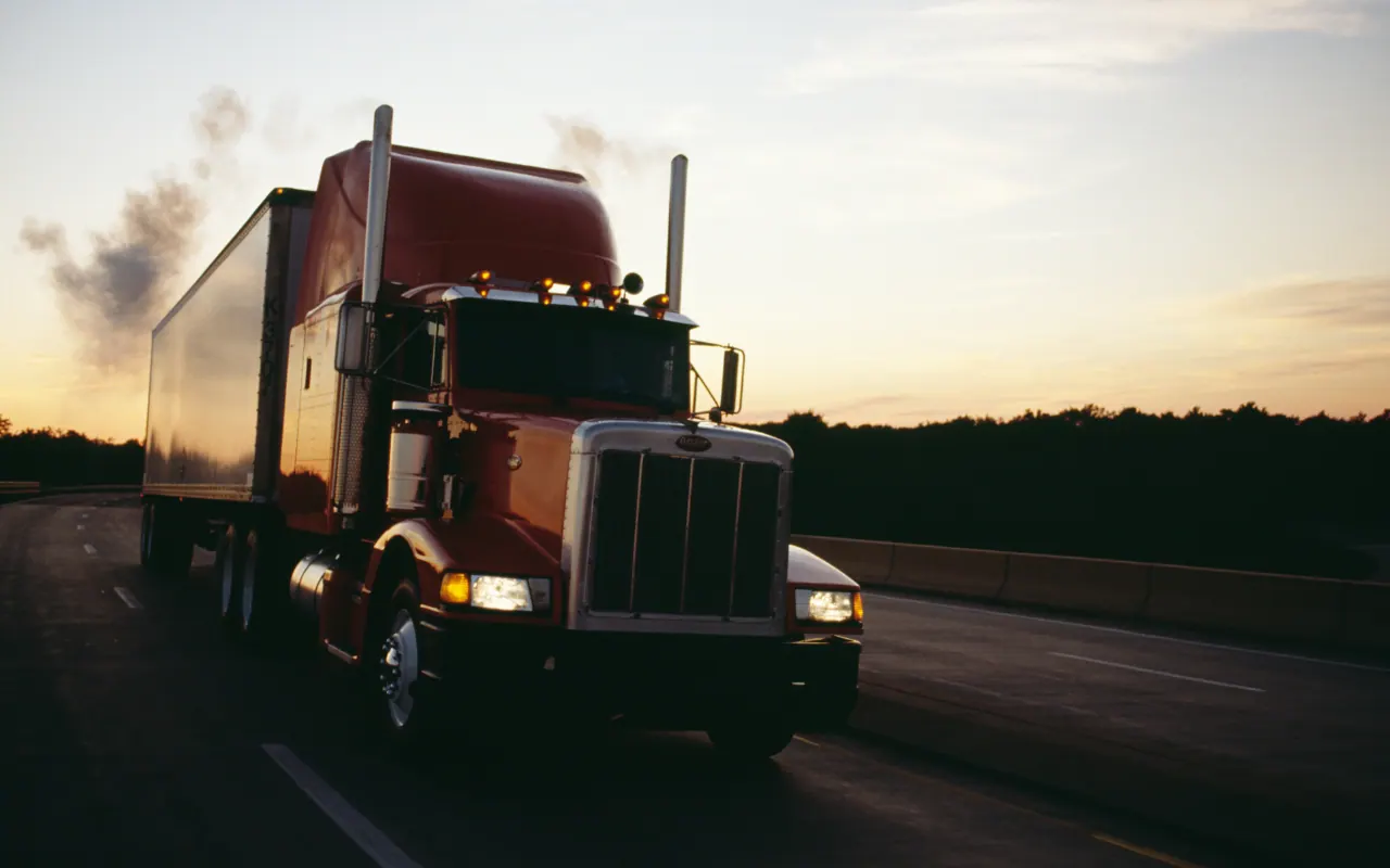 Semi truck on the highway at sunset
